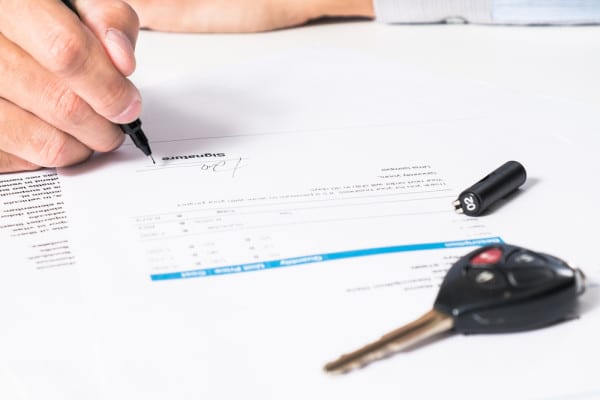 teen signing driving contract